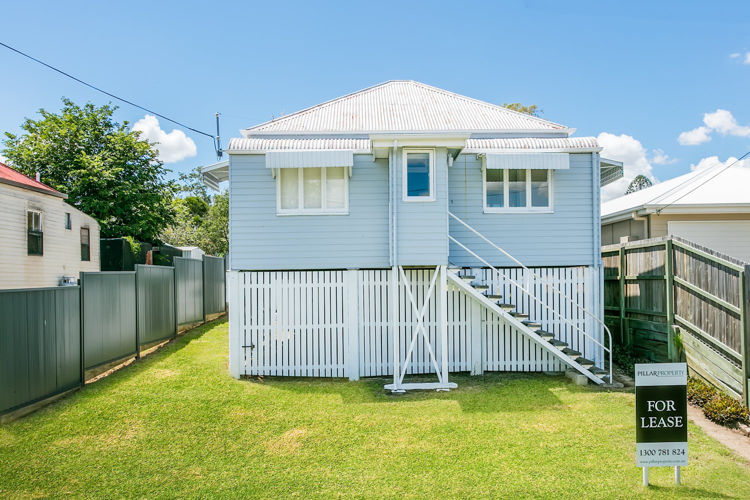 The same house after renovation, with the Pillar For Lease sign